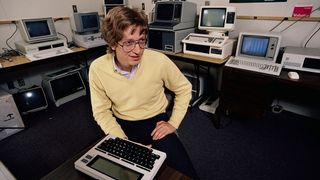 A young Bill Gates sitting among various computer hardware.